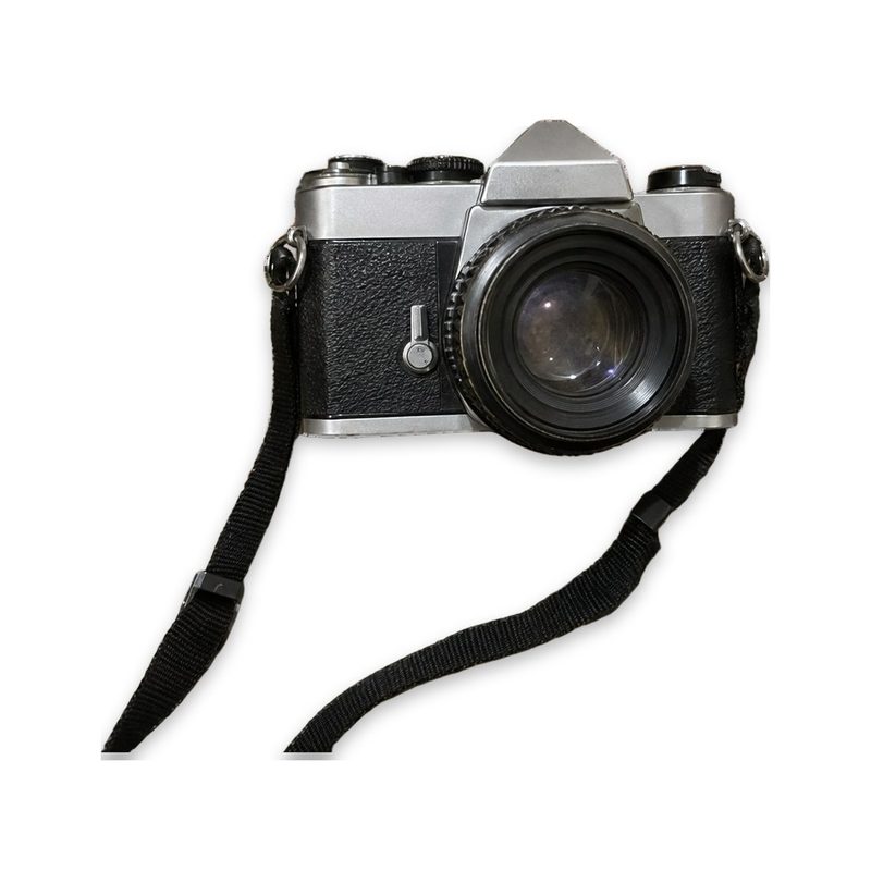 The camera and strap alone on white, with the remote removed